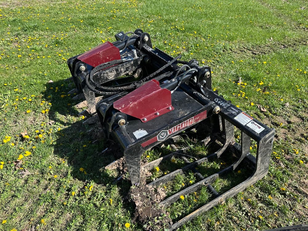 Vortex tiller attachment on grass, showcasing dual blades and hydraulic system.